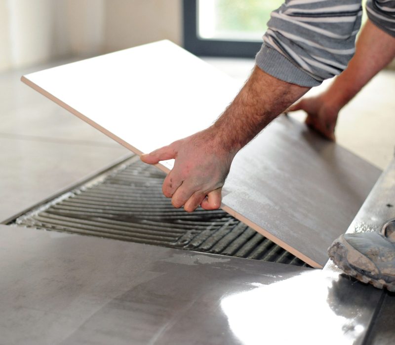 Man laying floor tiles